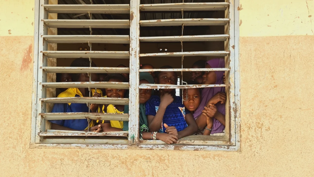 children looking through window